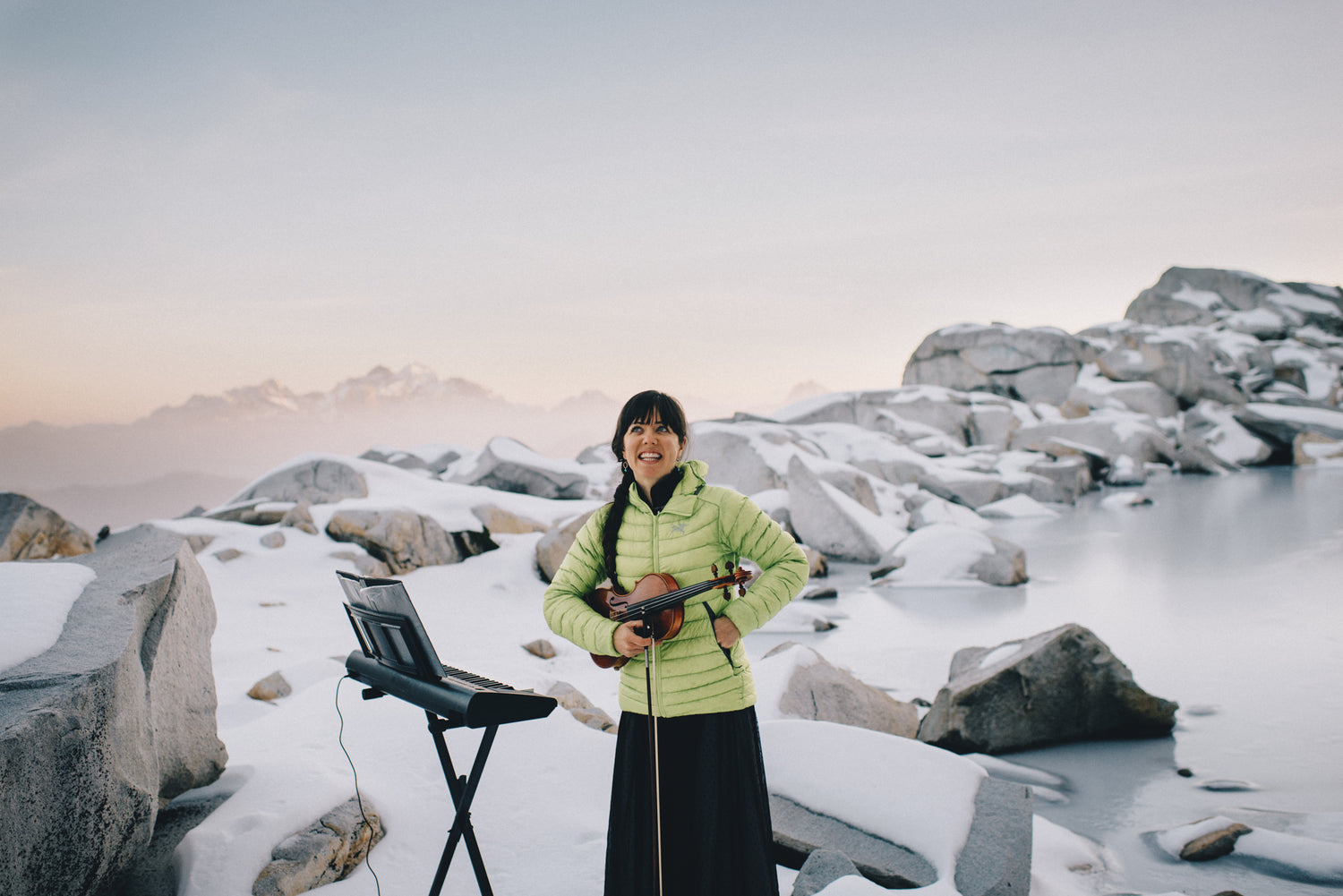Anastasia Allison of The Musical Mountaineers stands in front of a frozen lake. Photo by Karen Wang.