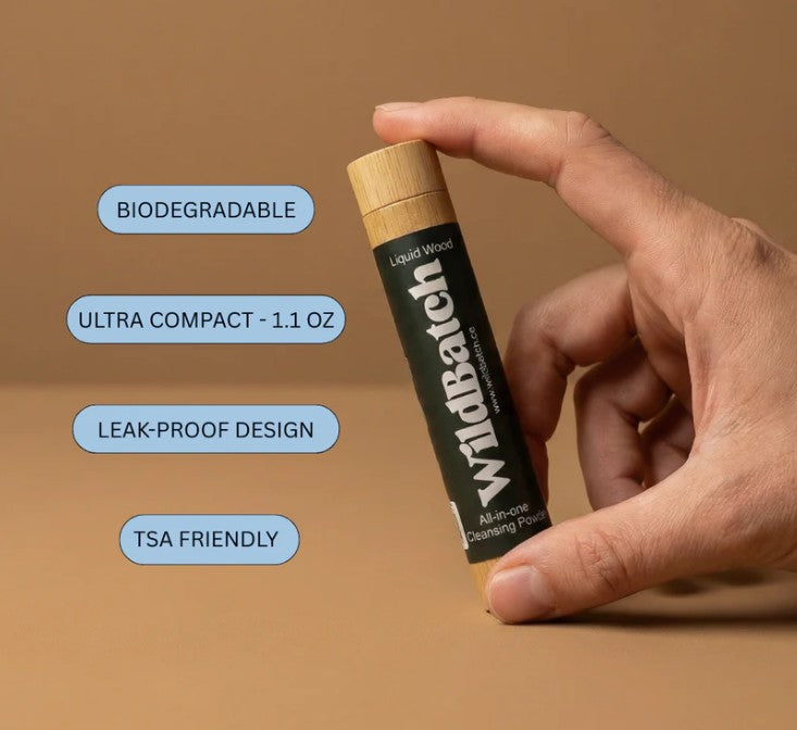 Person holding WildBatch All-in-one Cleansing Powder during an outdoor adventure