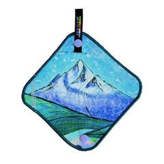 A Kula Cloth benefiting the PCTA featuring a blue painting of a mountain and a grassy field.  
